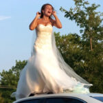 I Stepped Outside One Morning And Saw A Woman In A Wedding Dress On My Husband’s Car Roof