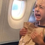 In the airplane restroom, I discovered a weeping young boy holding a paper bag, and he wasn’t listed among the passengers.
